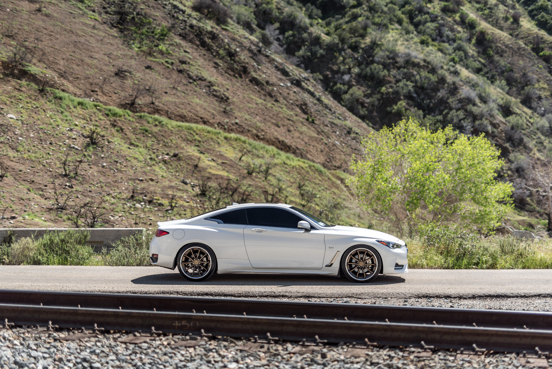 A White 2017 Infiniti Q60 on BD-23 20 Inch Bronze Chrome SS Lip Staggered Wheels