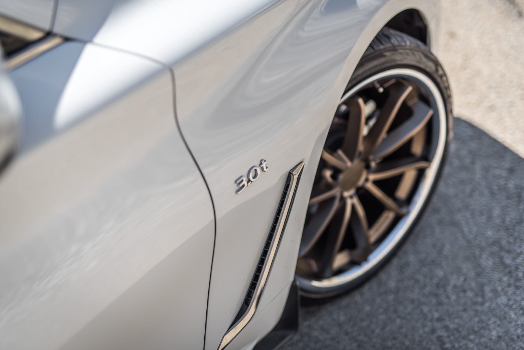 A White 2017 Infiniti Q60 on BD-23 20 Inch Bronze Chrome SS Lip Staggered Wheels