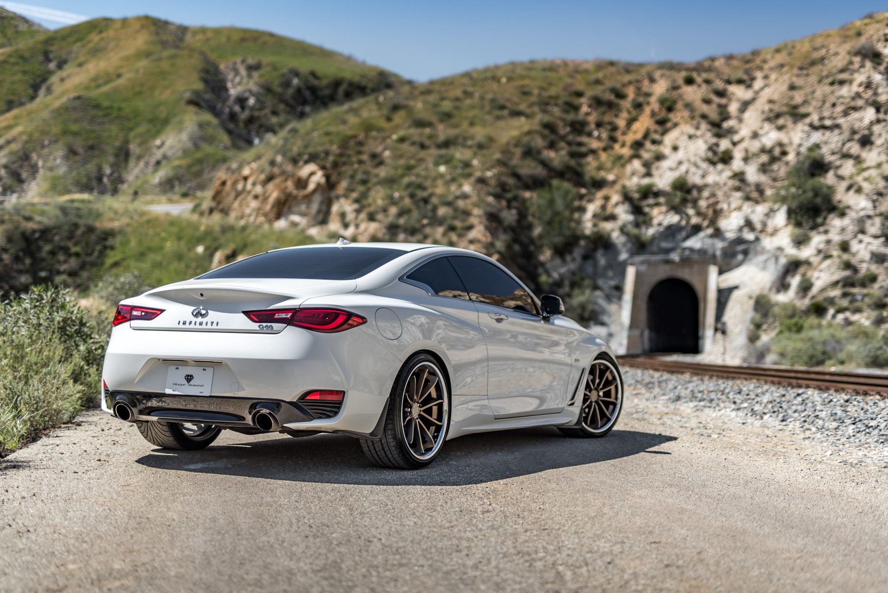 A White 2017 Infiniti Q60 on BD-23 20 Inch Bronze Chrome SS Lip Staggered Wheels