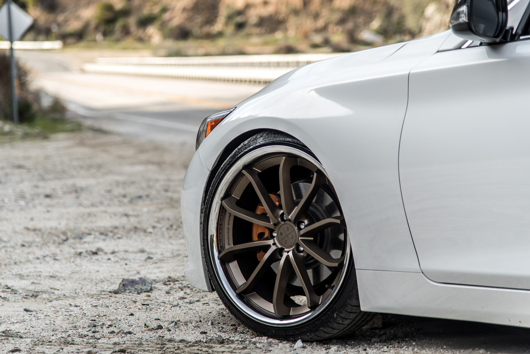 A White 2015 Infiniti Q50 on 20 Inch Blaque Diamond BD-23 Bronze Chrome Wheels