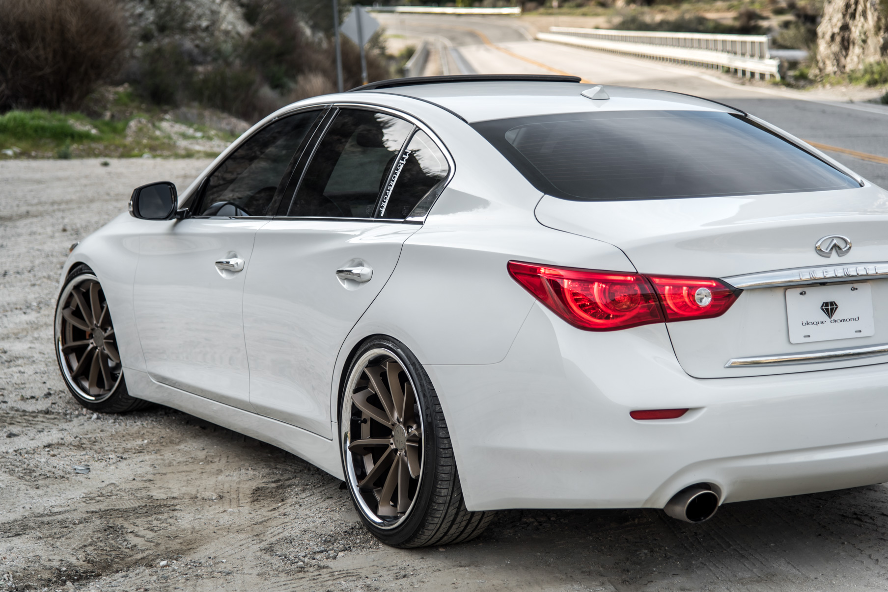 A White 2015 Infiniti Q50 on 20 Inch Blaque Diamond BD-23 Bronze Chrome Wheels