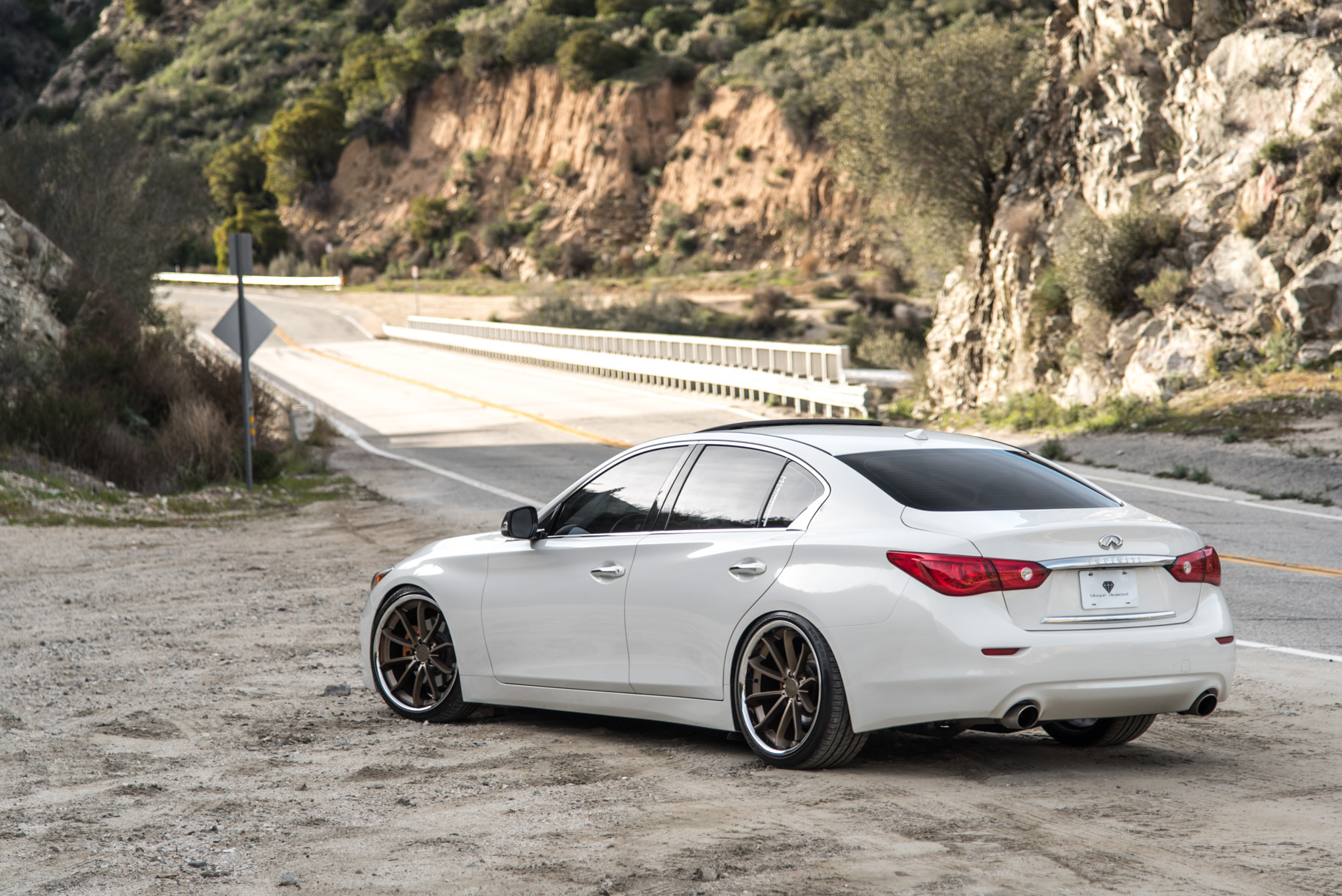A White 2015 Infiniti Q50 on 20 Inch Blaque Diamond BD-23 Bronze Chrome Wheels