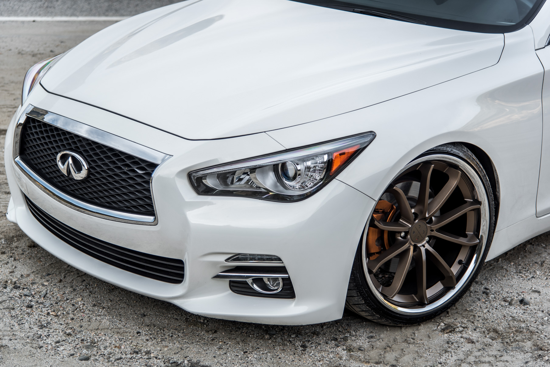 A White 2015 Infiniti Q50 on 20 Inch Blaque Diamond BD-23 Bronze Chrome Wheels