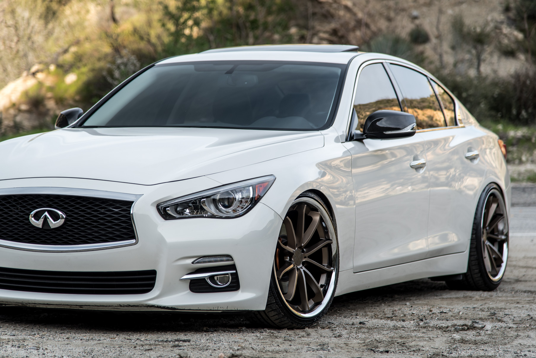 A White 2015 Infiniti Q50 on 20 Inch Blaque Diamond BD-23 Bronze Chrome Wheels