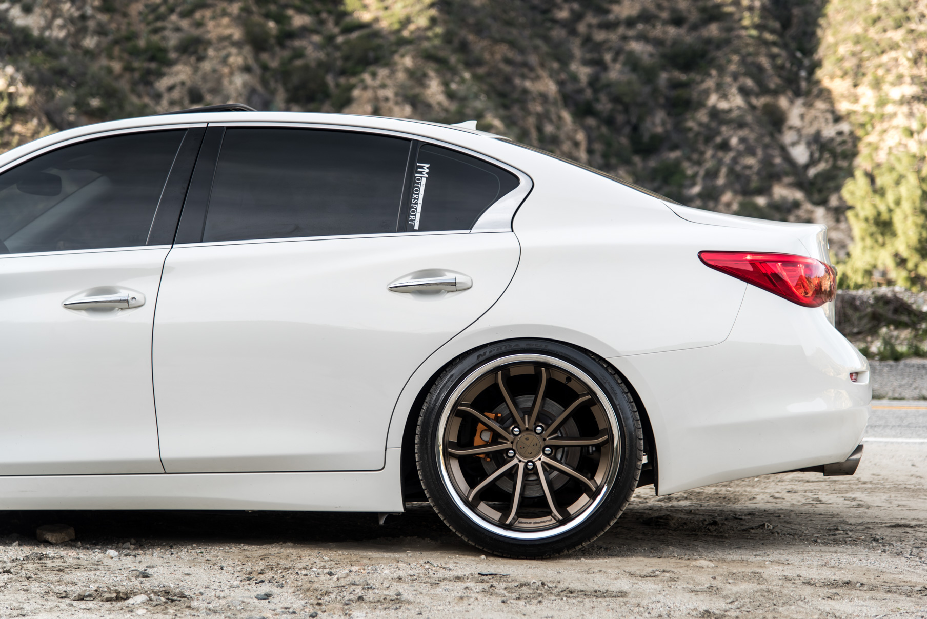 A White 2015 Infiniti Q50 on 20 Inch Blaque Diamond BD-23 Bronze Chrome Wheels