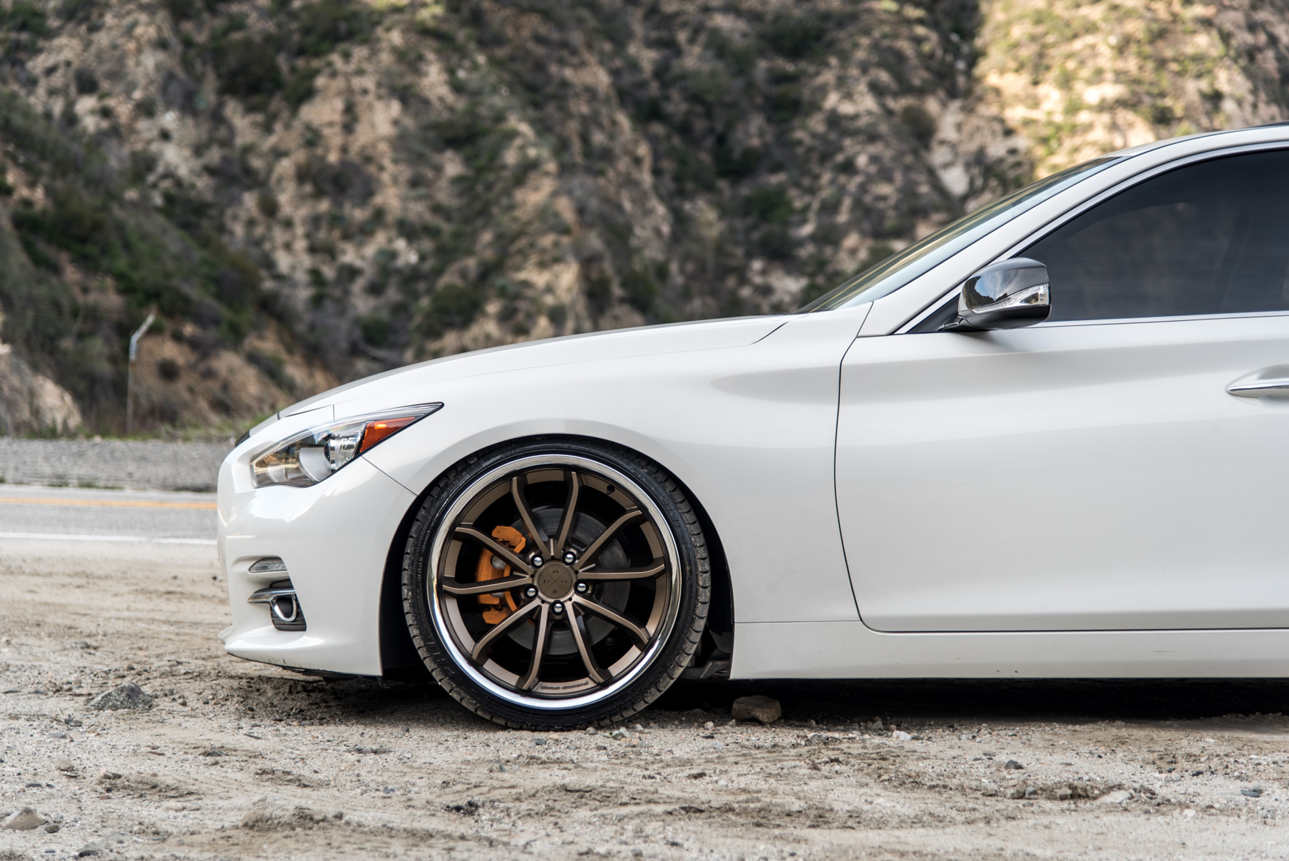 A White 2015 Infiniti Q50 on 20 Inch Blaque Diamond BD-23 Bronze Chrome Wheels