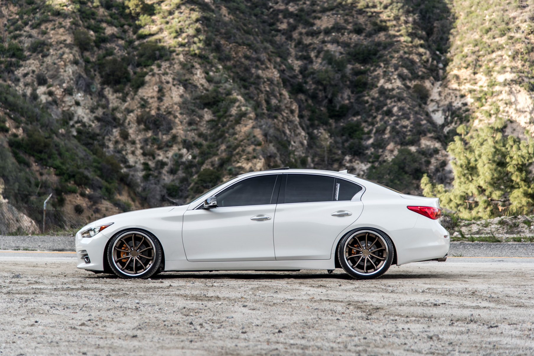 A White 2015 Infiniti Q50 on 20 Inch Blaque Diamond BD-23 Bronze Chrome Wheels