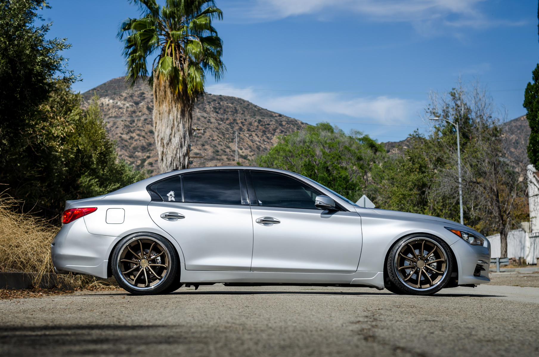 A Silver 2014 Infiniti Q50 on Blaque Diamond BD-23 Bronze Chrome Wheels