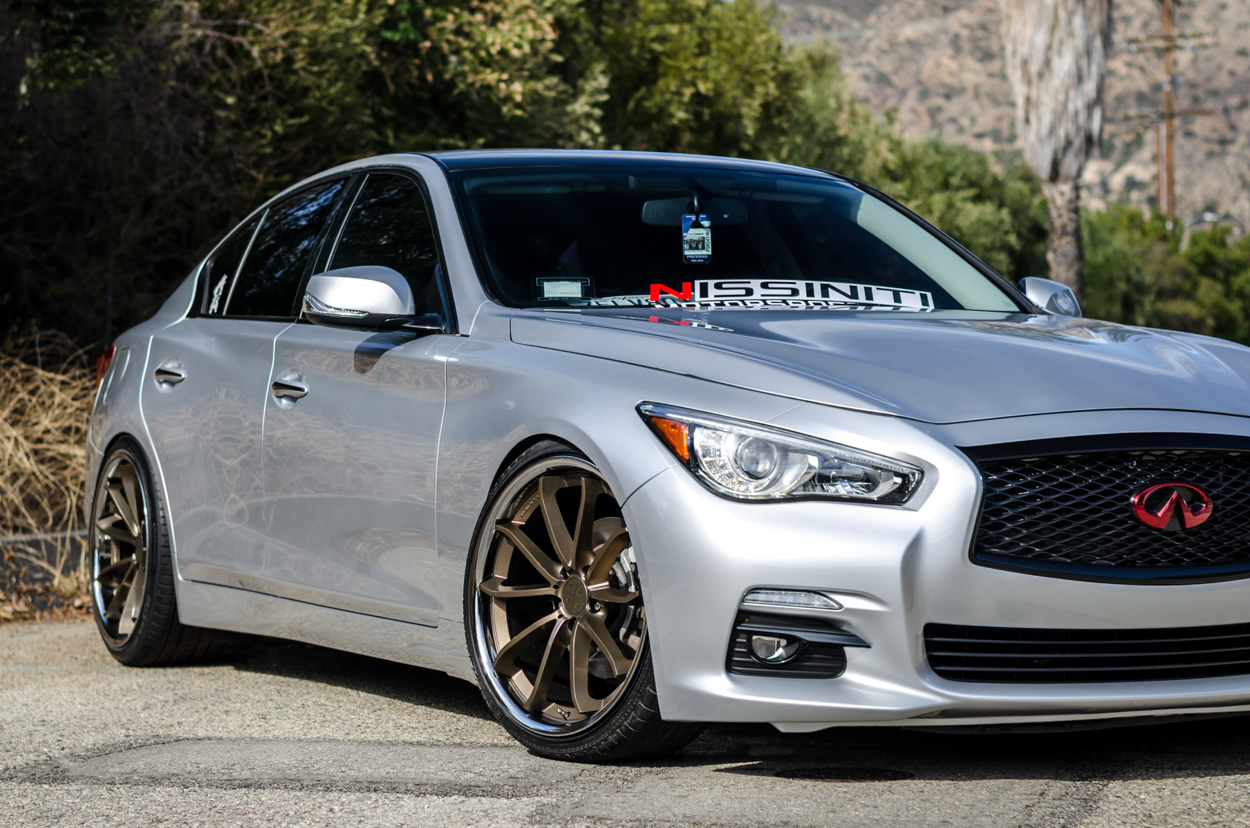A Silver 2014 Infiniti Q50 on Blaque Diamond BD-23 Bronze Chrome Wheels