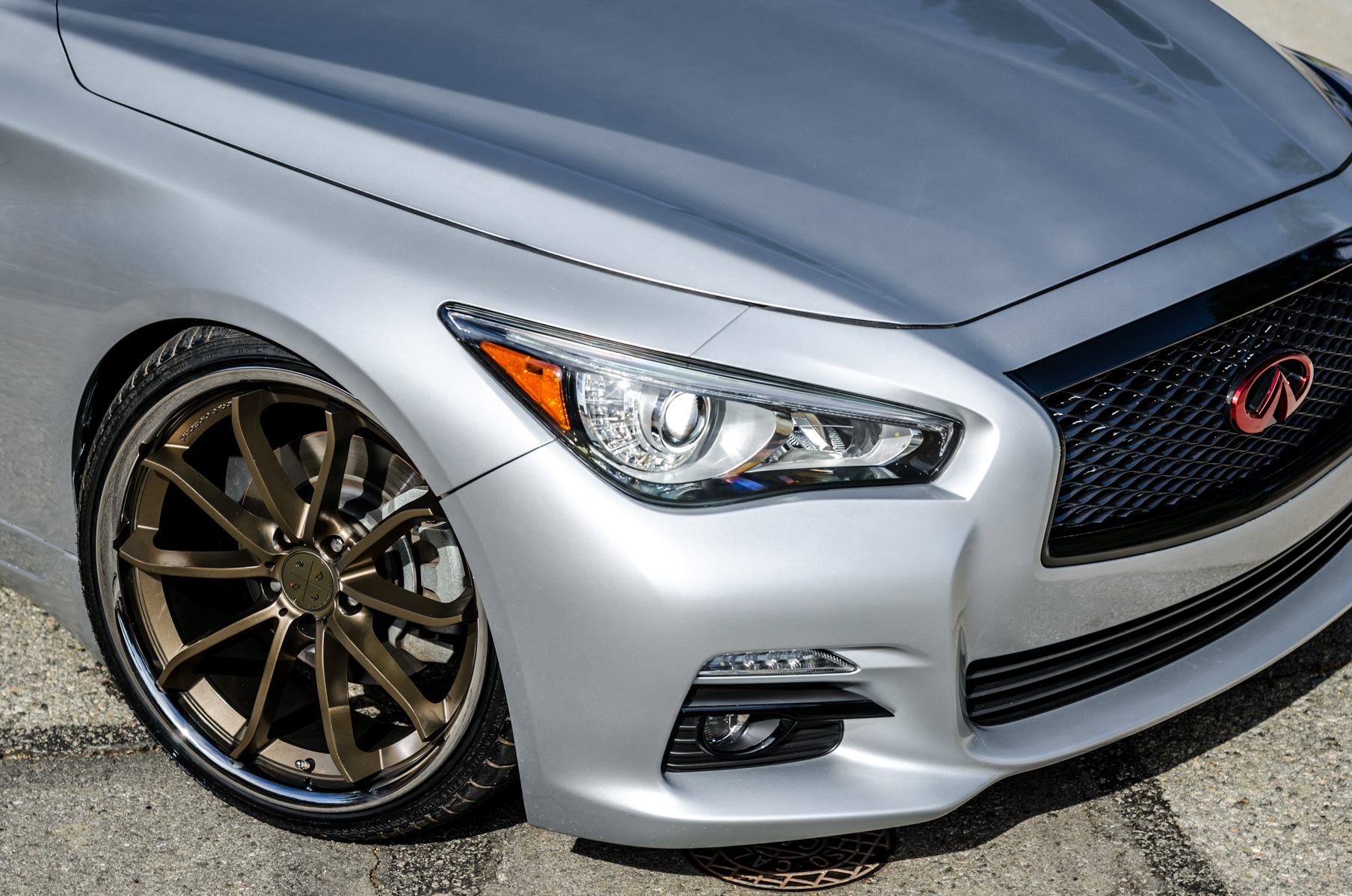 A Silver 2014 Infiniti Q50 on Blaque Diamond BD-23 Bronze Chrome Wheels