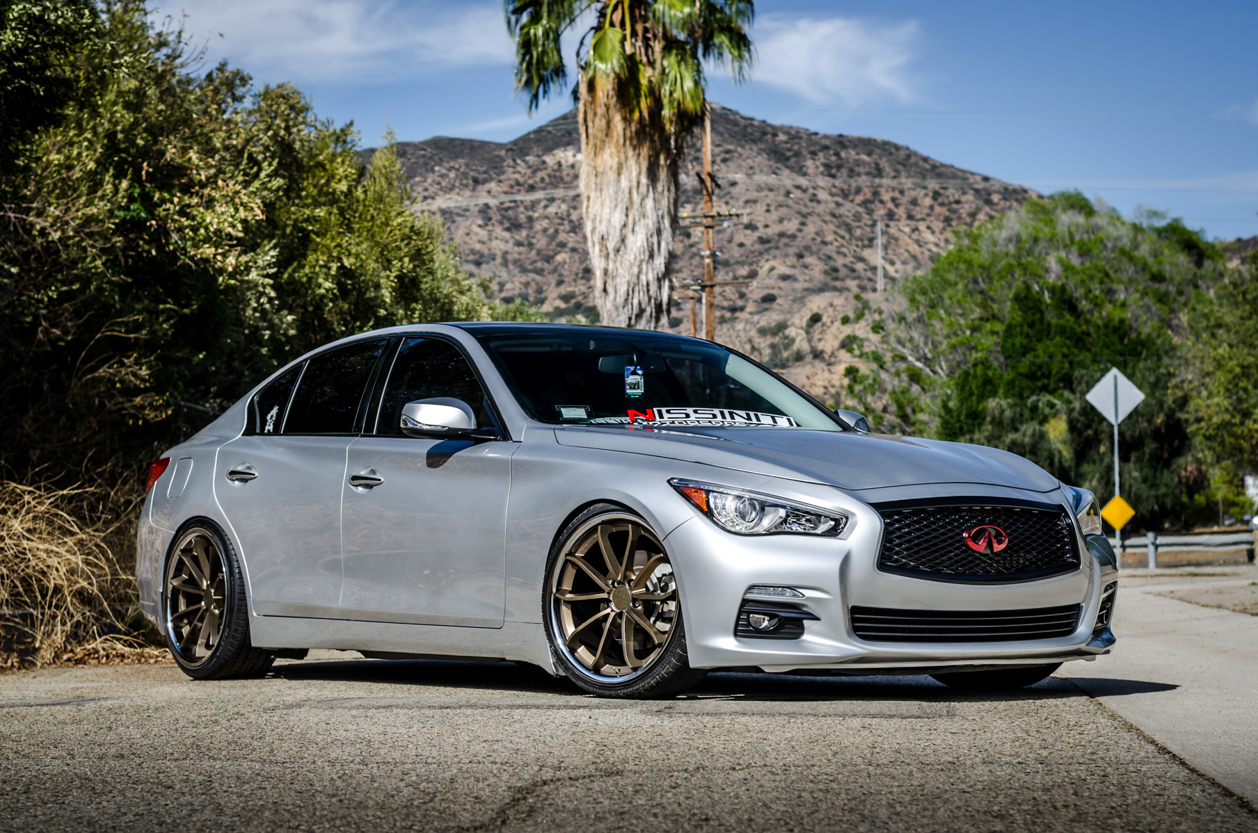 A Silver 2014 Infiniti Q50 on Blaque Diamond BD-23 Bronze Chrome Wheels
