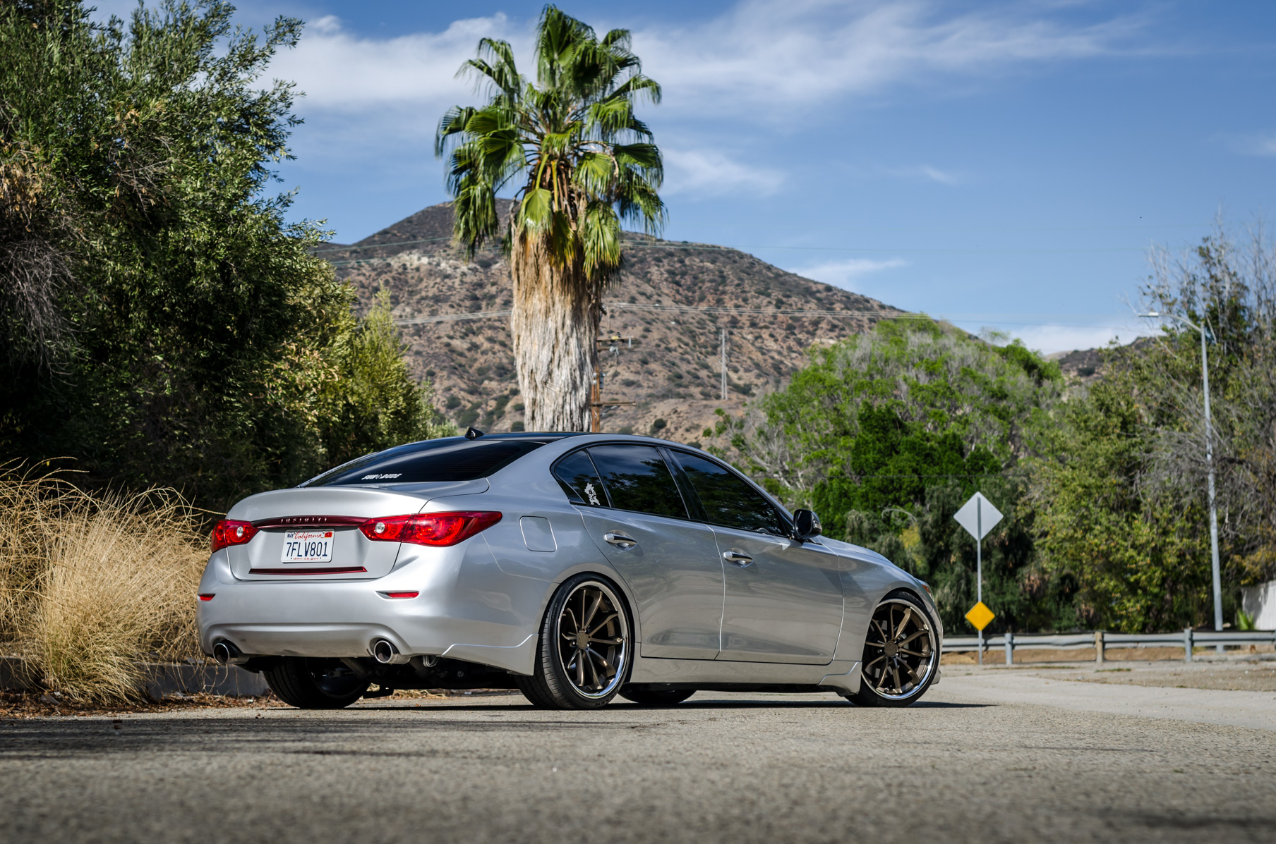 A Silver 2014 Infiniti Q50 on Blaque Diamond BD-23 Bronze Chrome Wheels