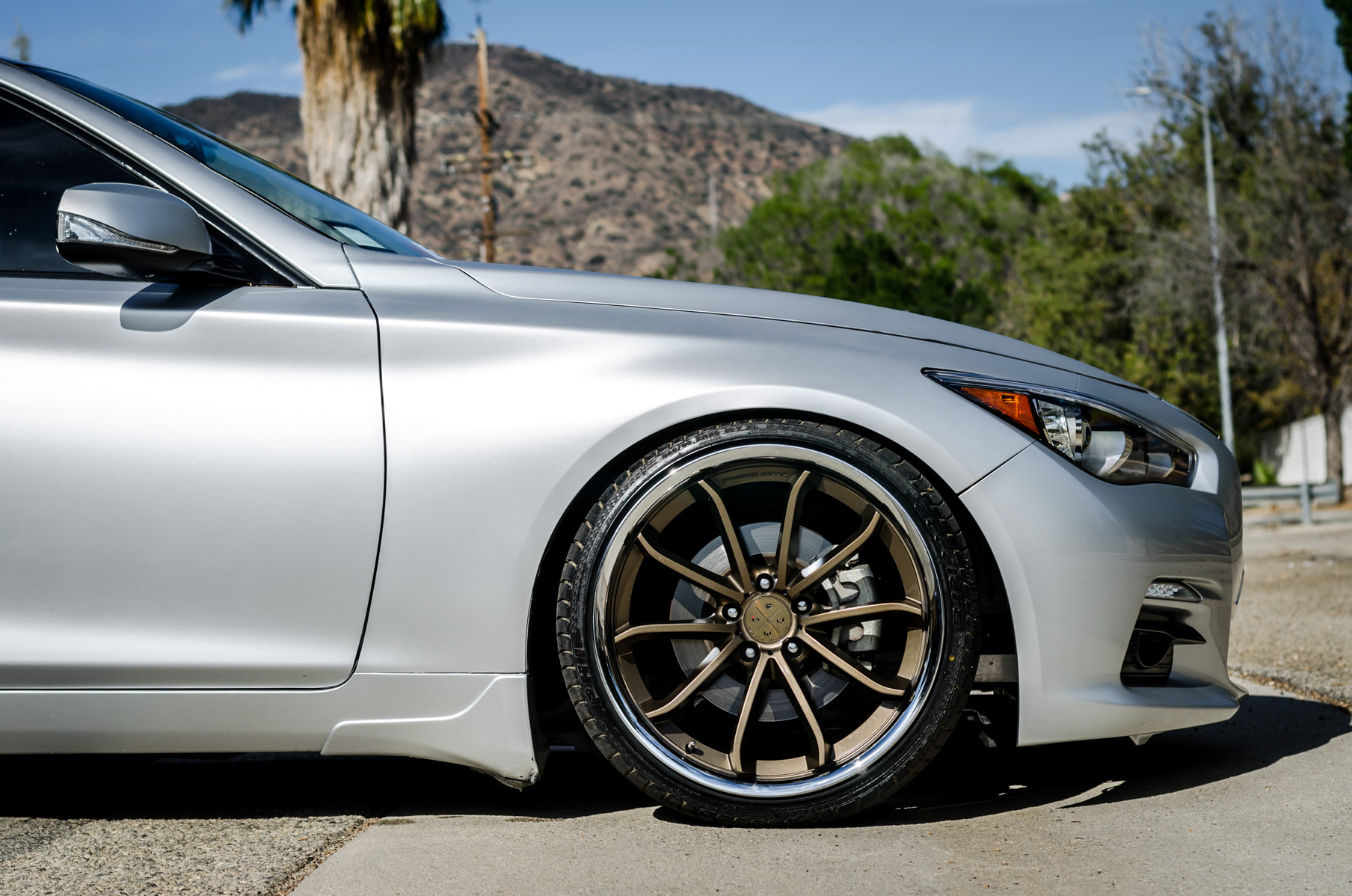 A Silver 2014 Infiniti Q50 on Blaque Diamond BD-23 Bronze Chrome Wheels