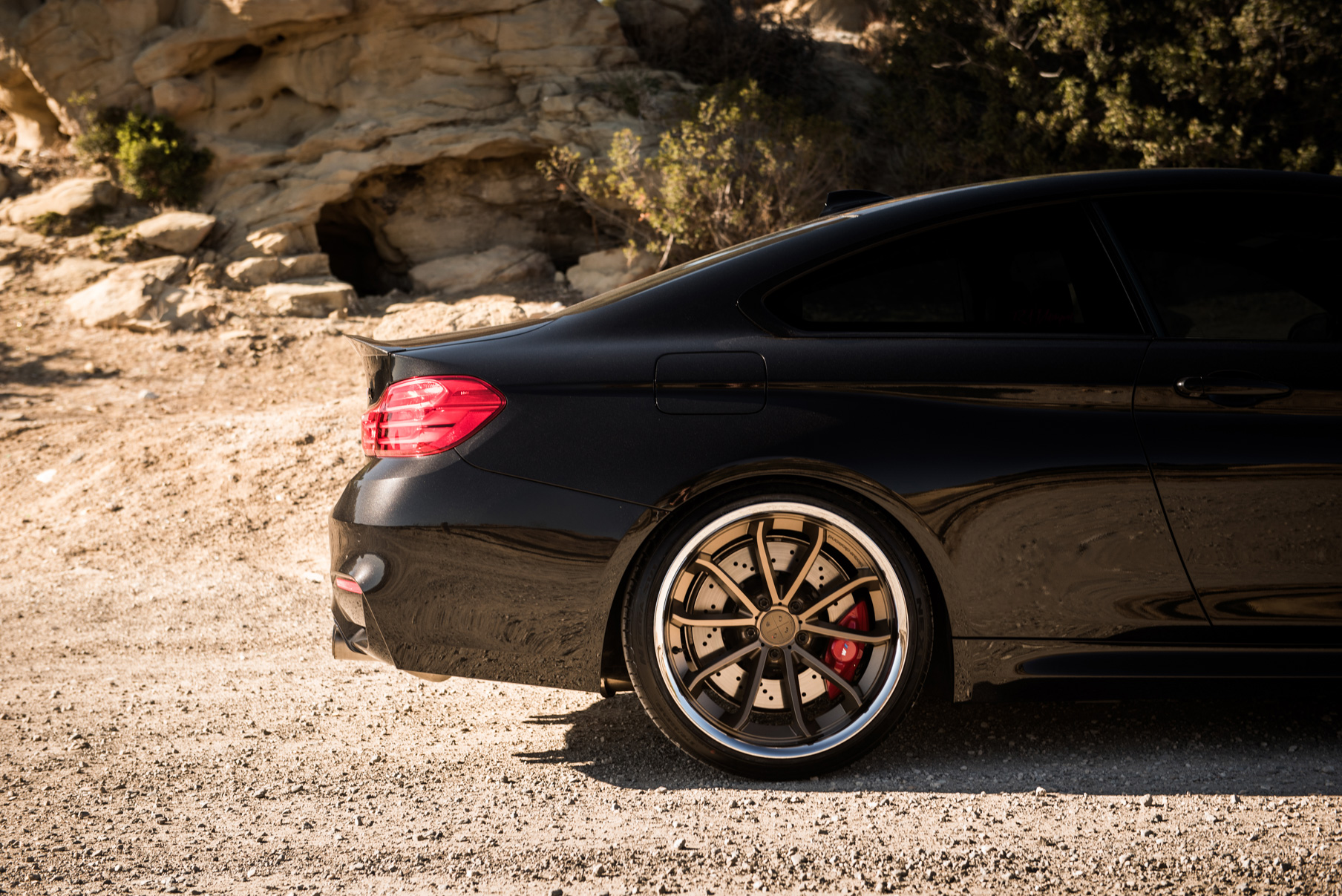 A 2015 BMW M4 on Staggered Blaque Diamond BD-23 Matte Bronze Wheels