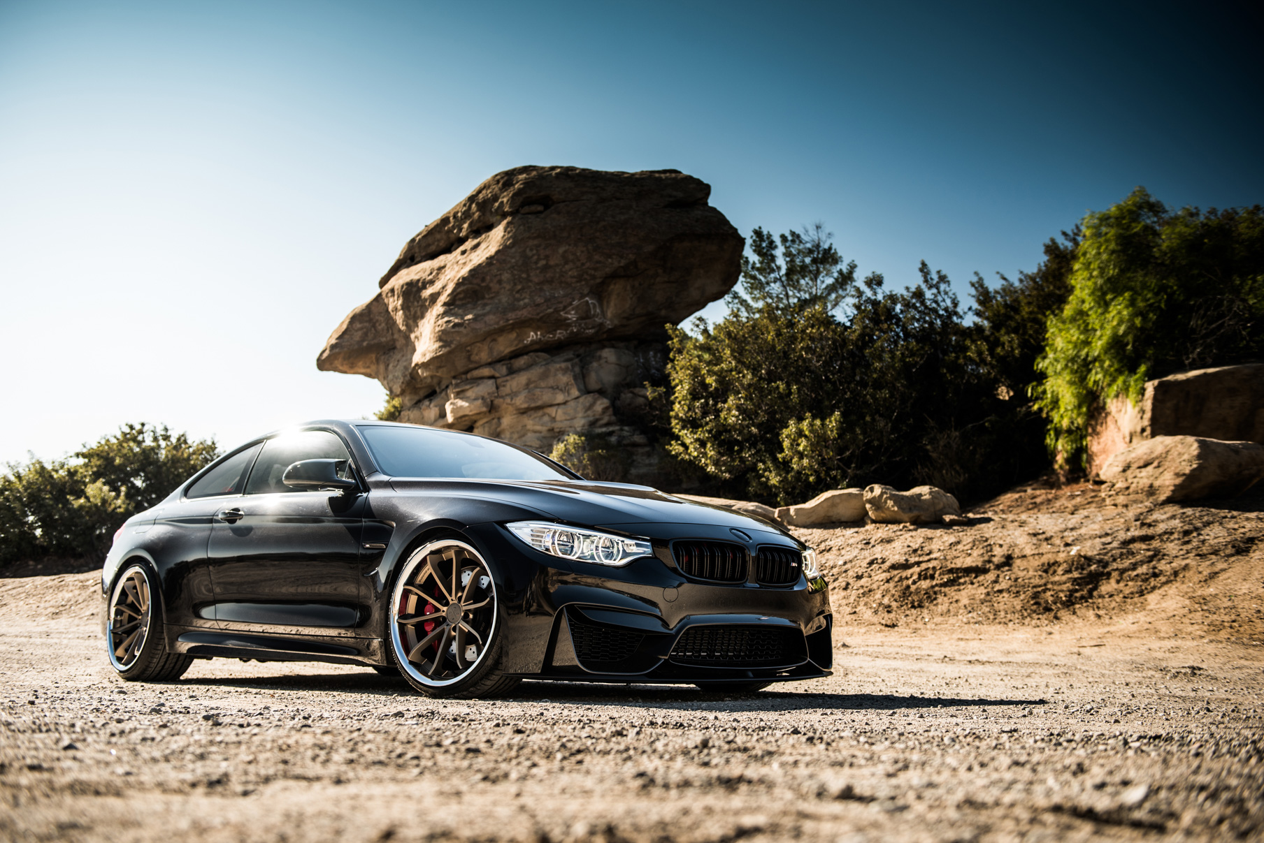 A 2015 BMW M4 on Staggered Blaque Diamond BD-23 Matte Bronze Wheels