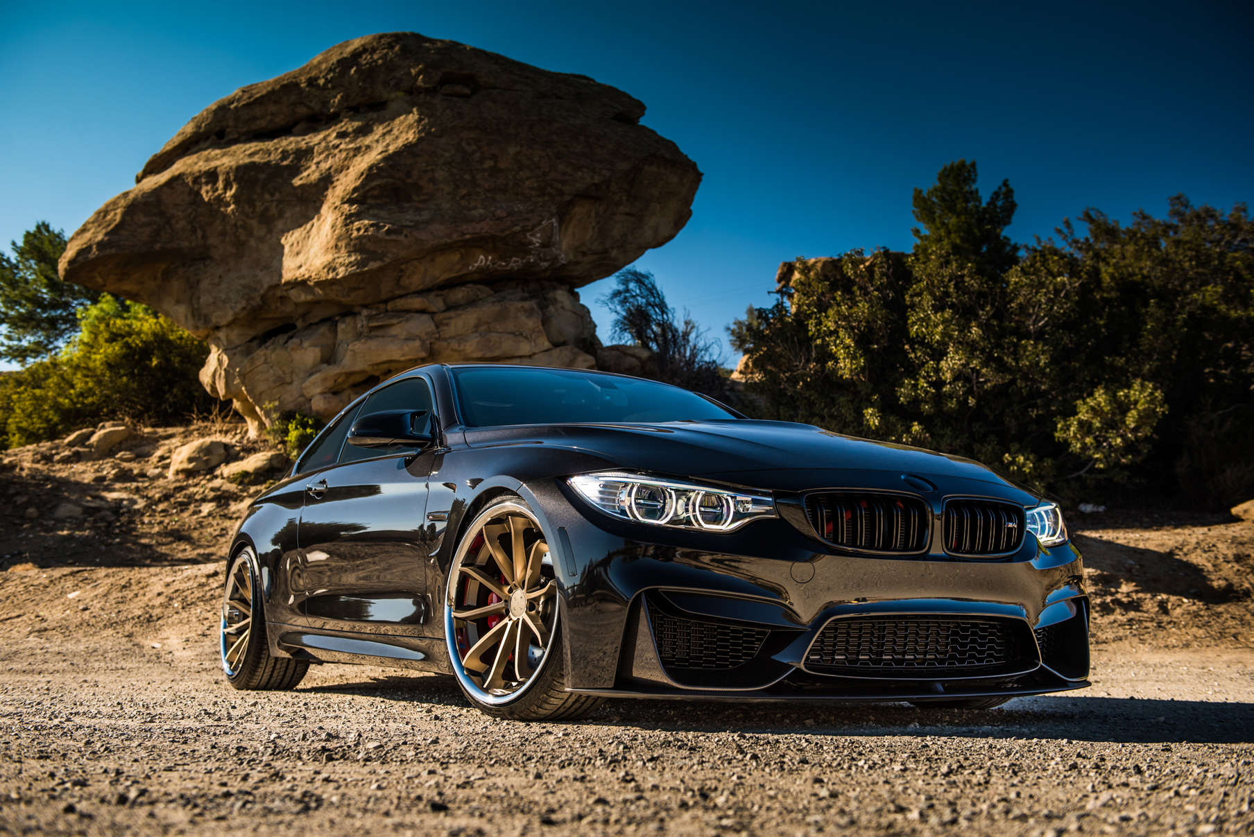 A 2015 BMW M4 on Staggered Blaque Diamond BD-23 Matte Bronze Wheels