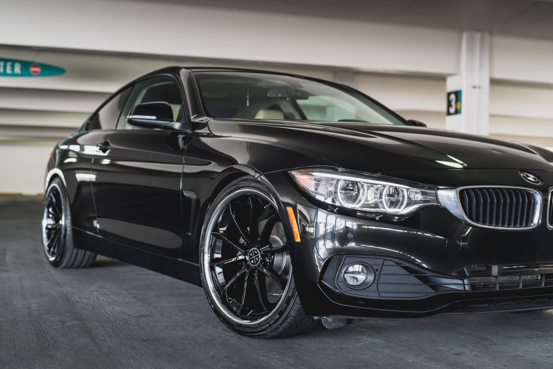 A 2014 BMW 428i on Staggered Blaque Diamond BD-23 Black with Chrome Lip Wheels