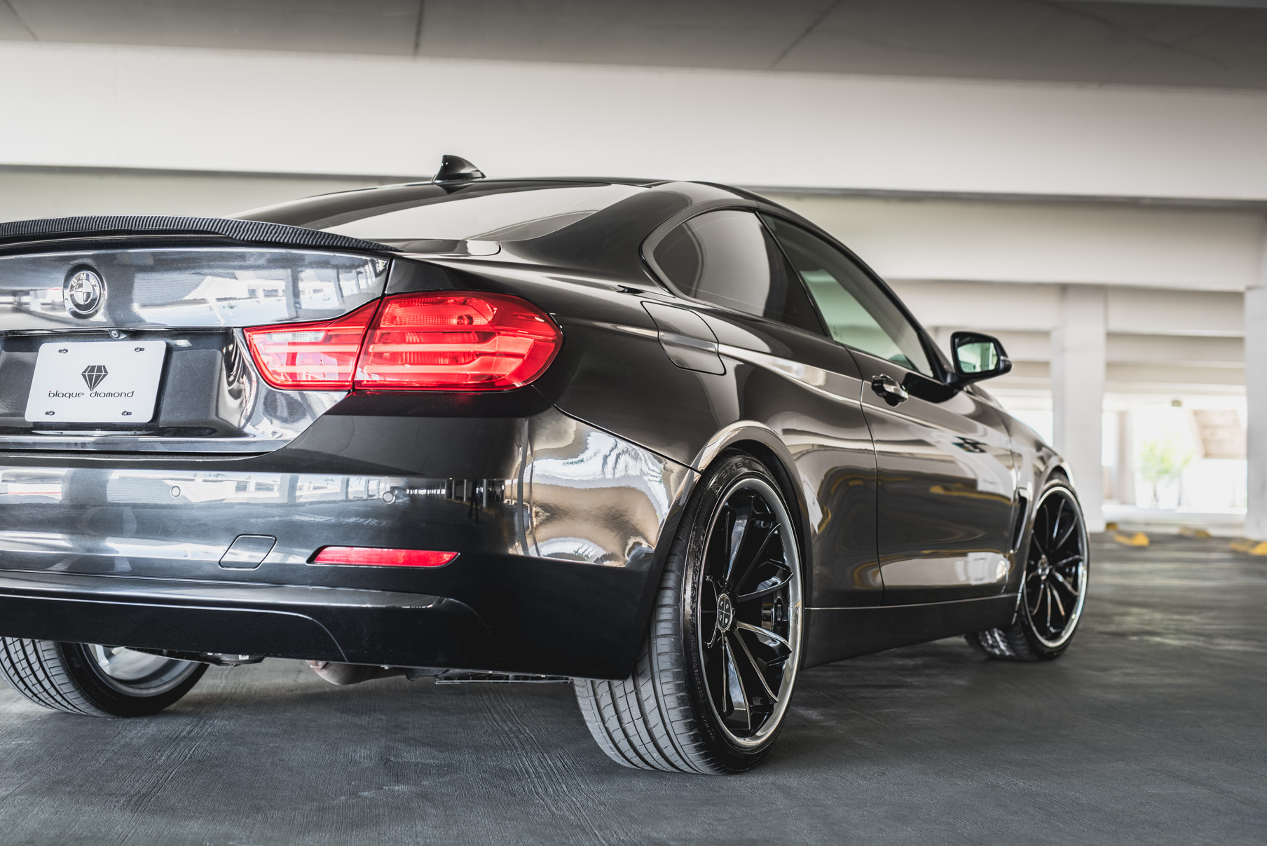 A 2014 BMW 428i on Staggered Blaque Diamond BD-23 Black with Chrome Lip Wheels