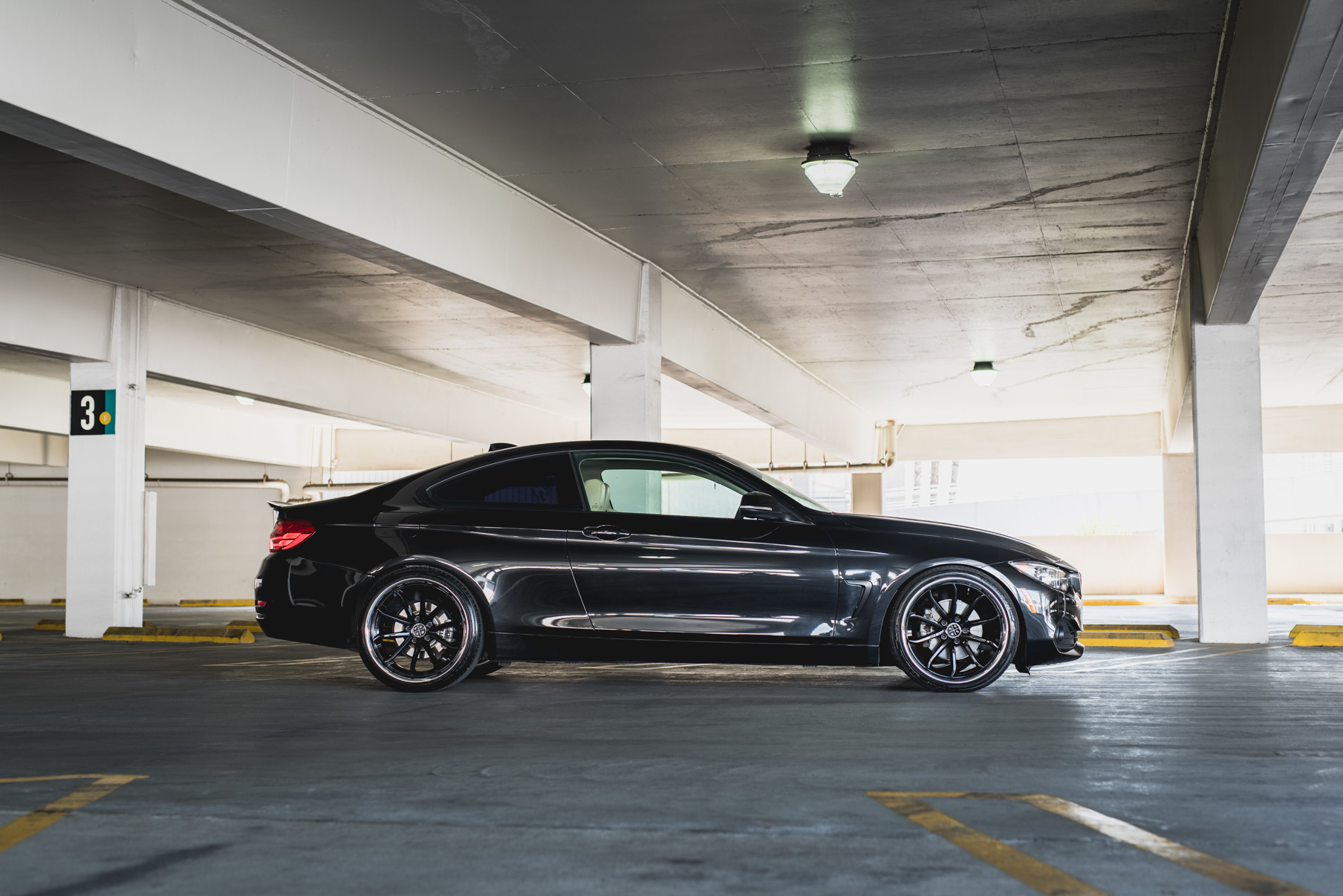 A 2014 BMW 428i on Staggered Blaque Diamond BD-23 Black with Chrome Lip Wheels