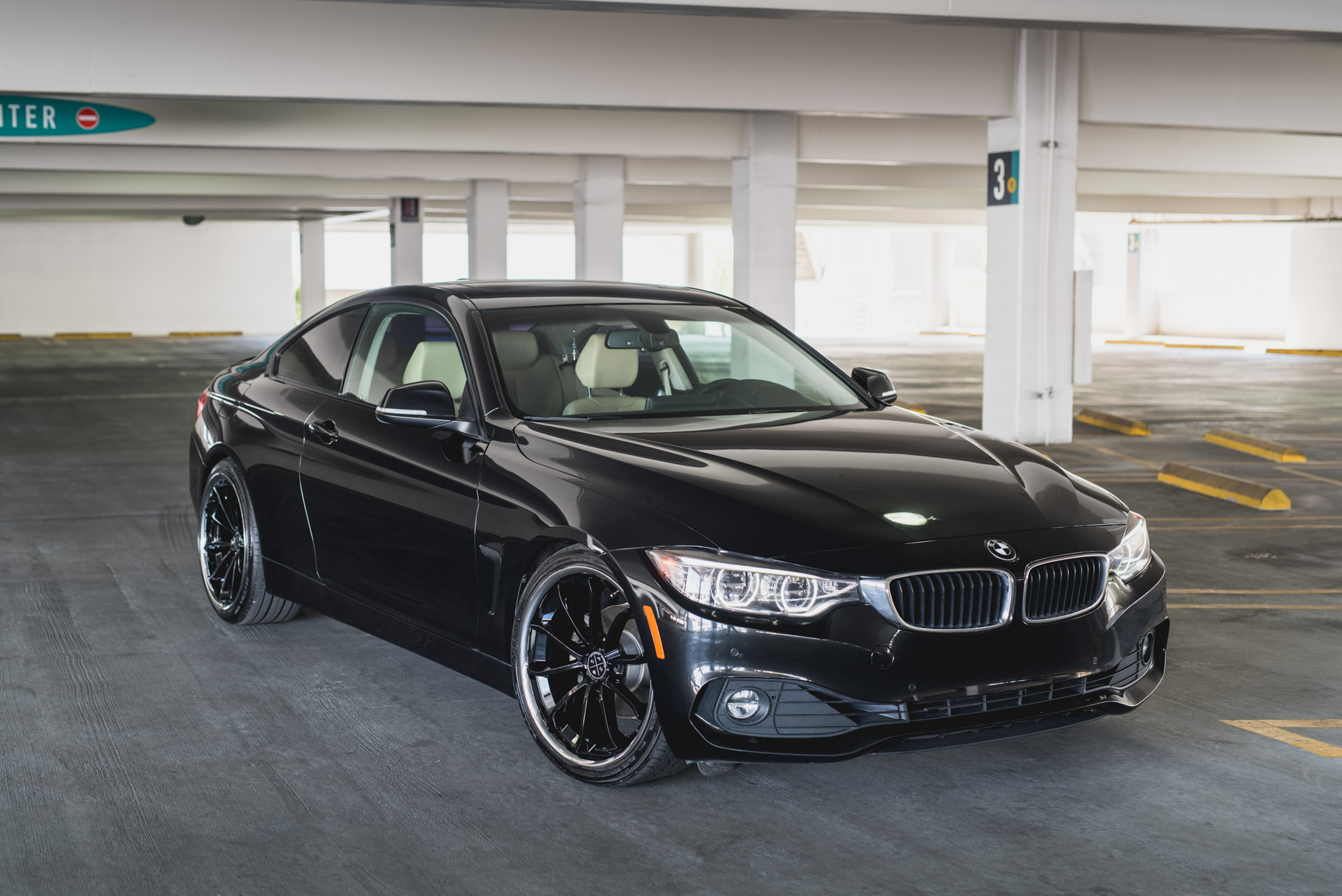 A 2014 BMW 428i on Staggered Blaque Diamond BD-23 Black with Chrome Lip Wheels