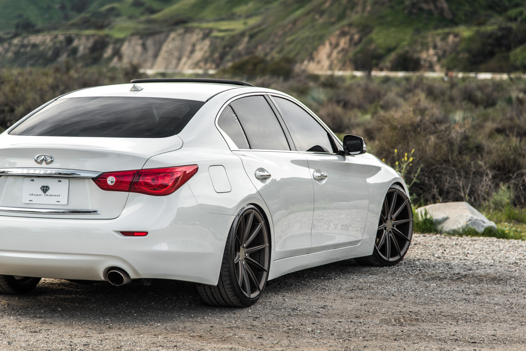 A 2015 Infiniti Q50 on 20 Inch Blaque Diamond BD-11 Matte Antique Bronze Wheels