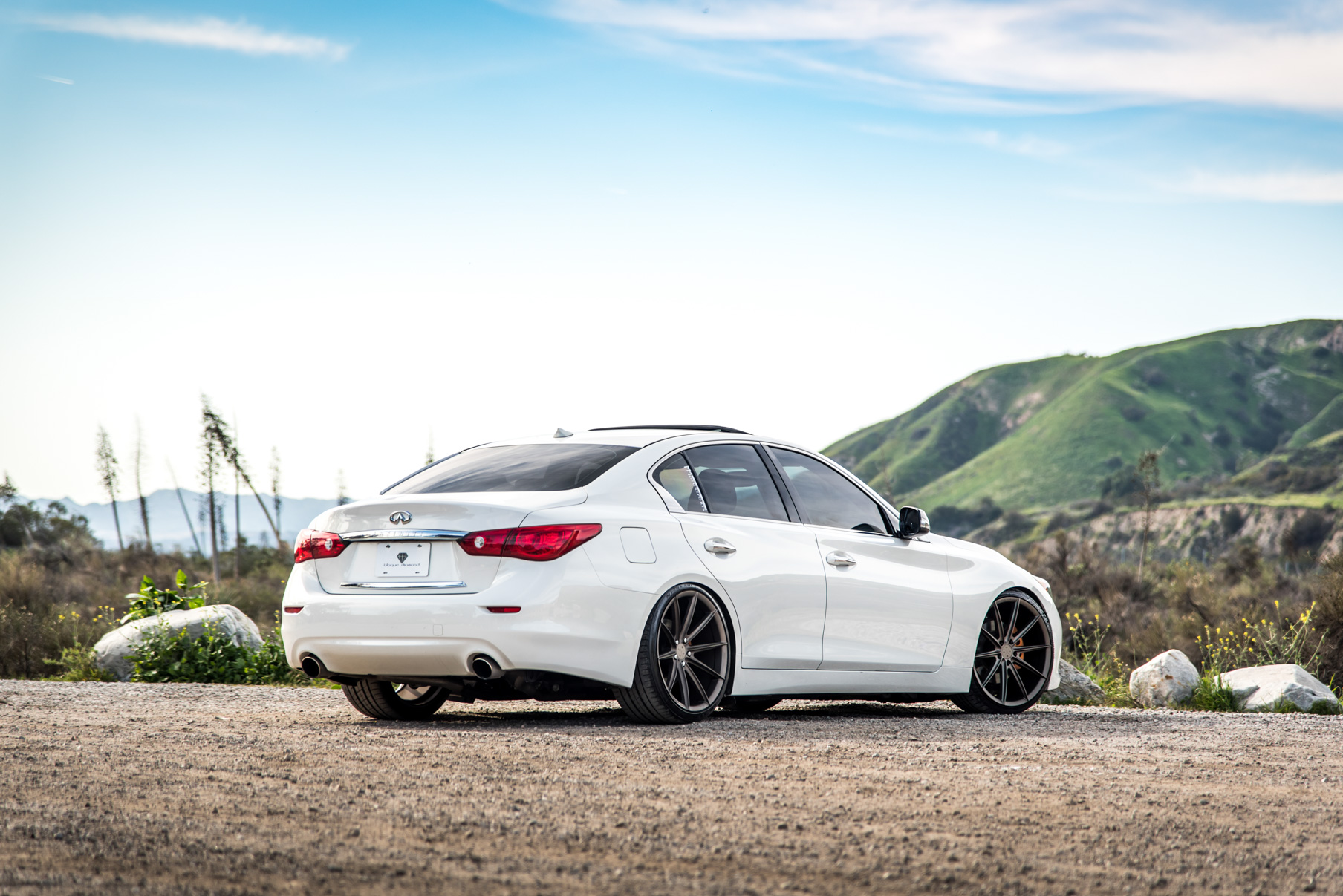 A 2015 Infiniti Q50 on 20 Inch Blaque Diamond BD-11 Matte Antique Bronze Wheels