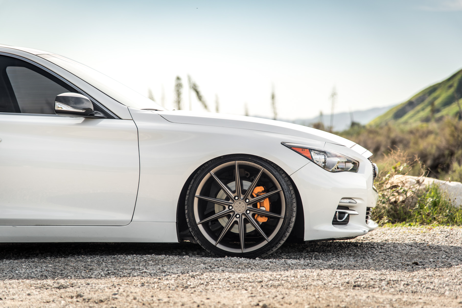 A 2015 Infiniti Q50 on 20 Inch Blaque Diamond BD-11 Matte Antique Bronze Wheels