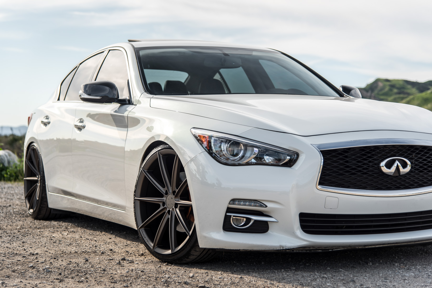 A 2015 Infiniti Q50 on 20 Inch Blaque Diamond BD-11 Matte Antique Bronze Wheels