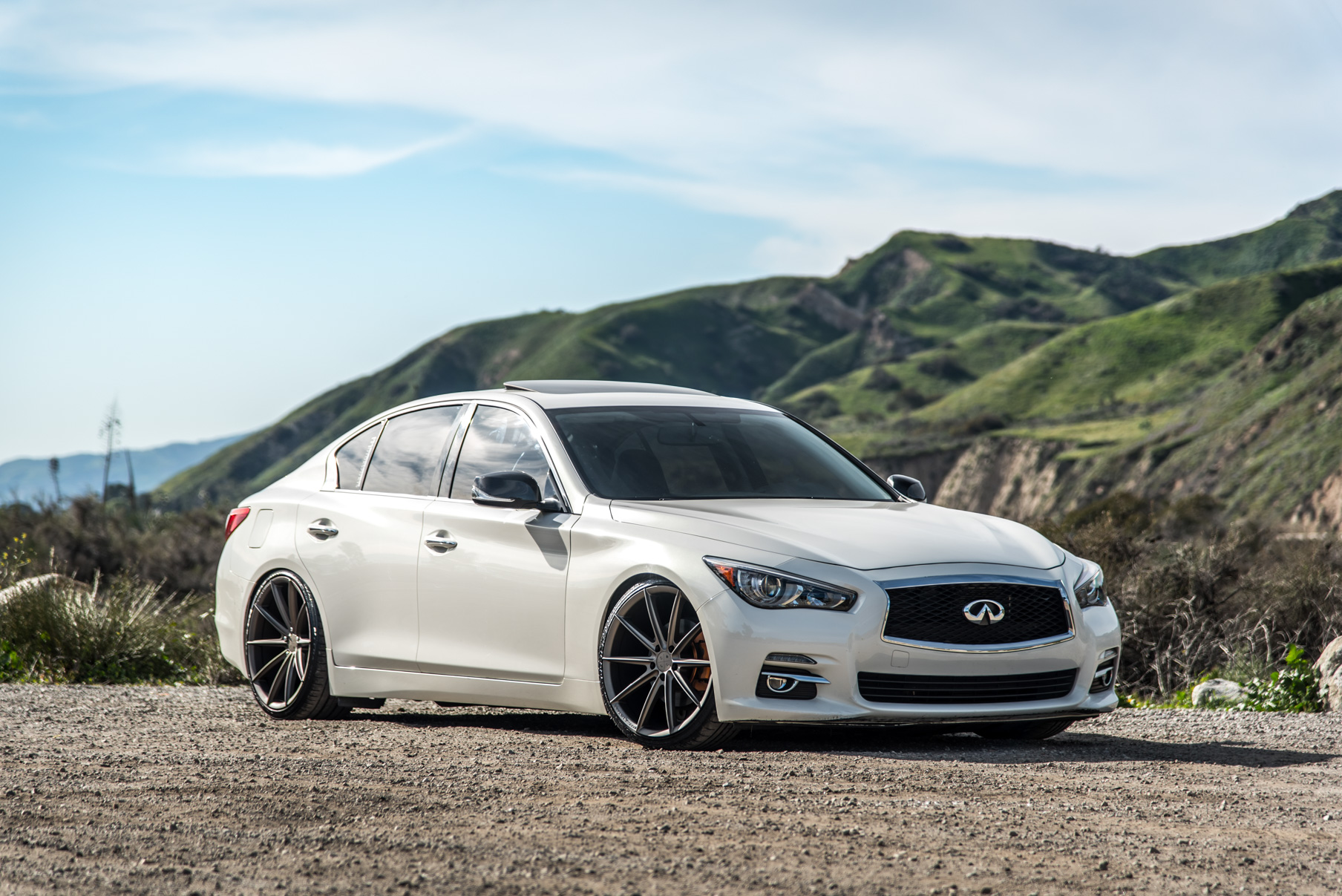 A 2015 Infiniti Q50 on 20 Inch Blaque Diamond BD-11 Matte Antique Bronze Wheels