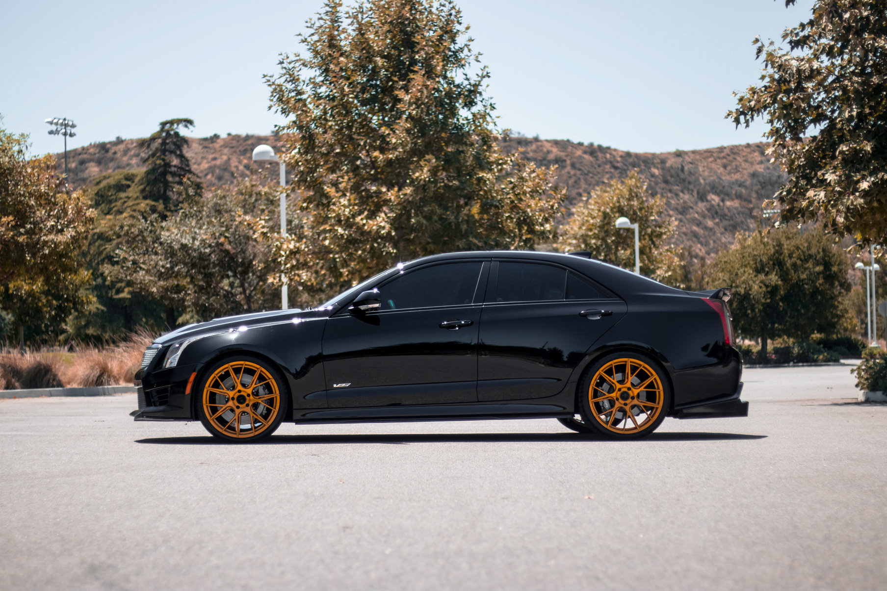 A 2017 Cadillac ATSV on 20 Inch Blaque Diamond BD-F18 Gold Wheels