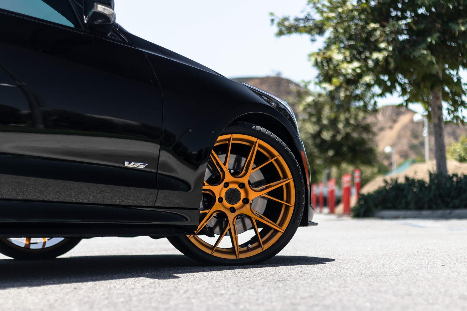 A 2017 Cadillac ATSV on 20 Inch Blaque Diamond BD-F18 Gold Wheels