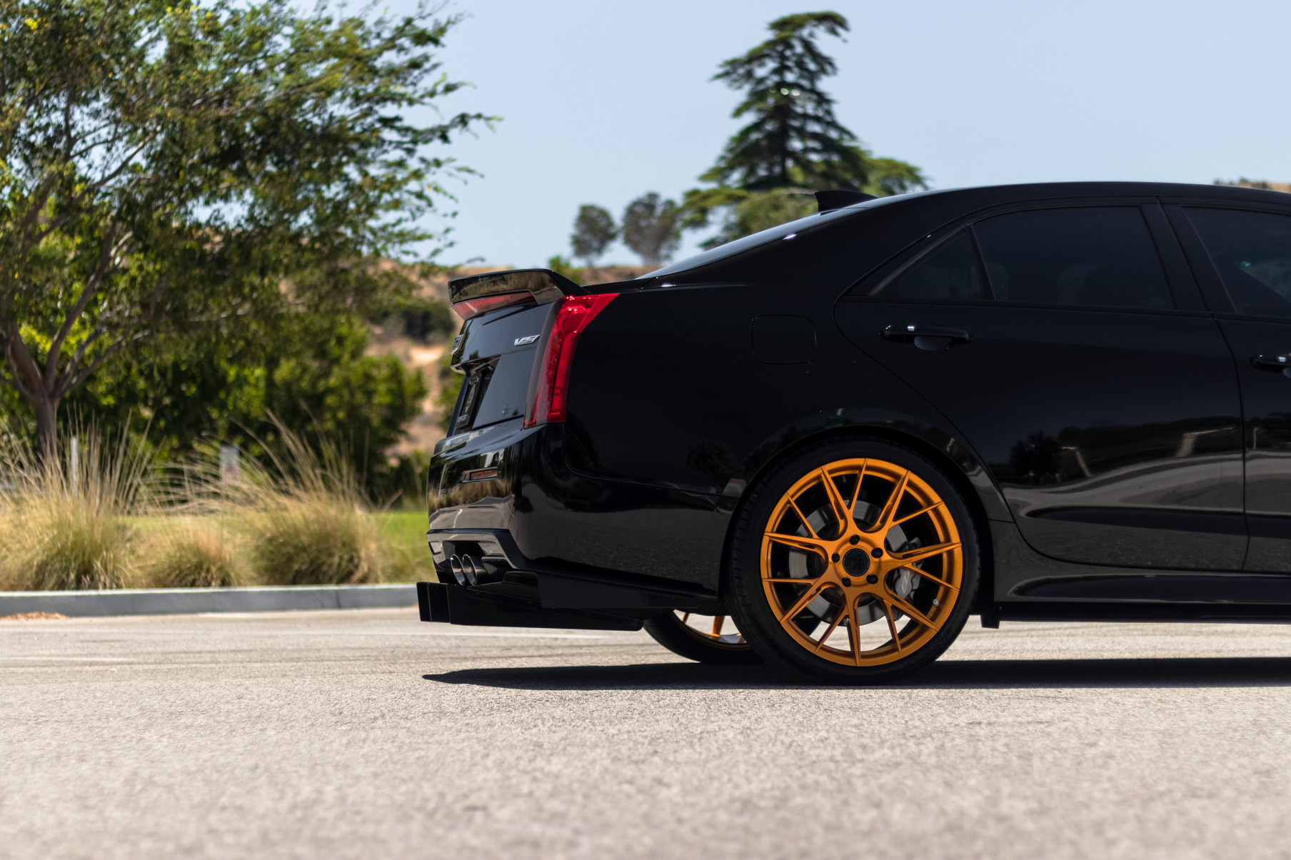 A 2017 Cadillac ATSV on 20 Inch Blaque Diamond BD-F18 Gold Wheels