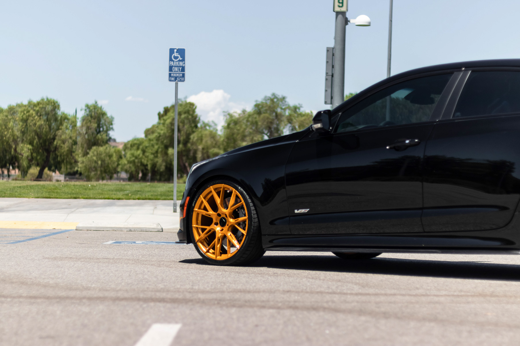 A 2017 Cadillac ATSV on 20 Inch Blaque Diamond BD-F18 Gold Wheels