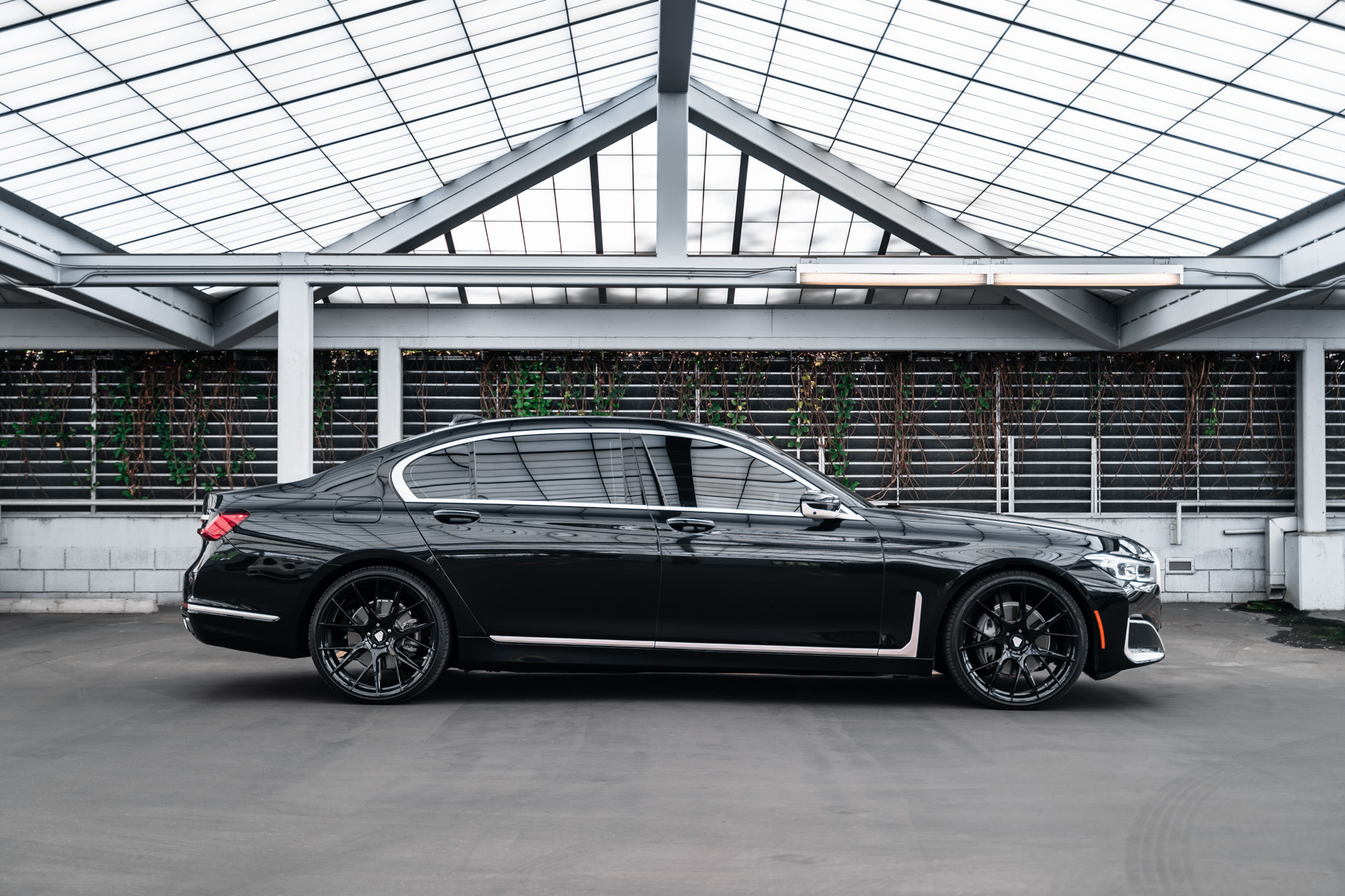 A 2020 BMW 740i on 20 Inch Blaque Diamond BD-F18 Gloss Black Wheels