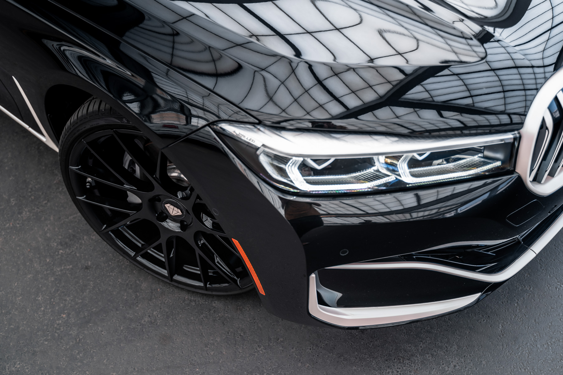 A 2020 BMW 740i on 20 Inch Blaque Diamond BD-F18 Gloss Black Wheels