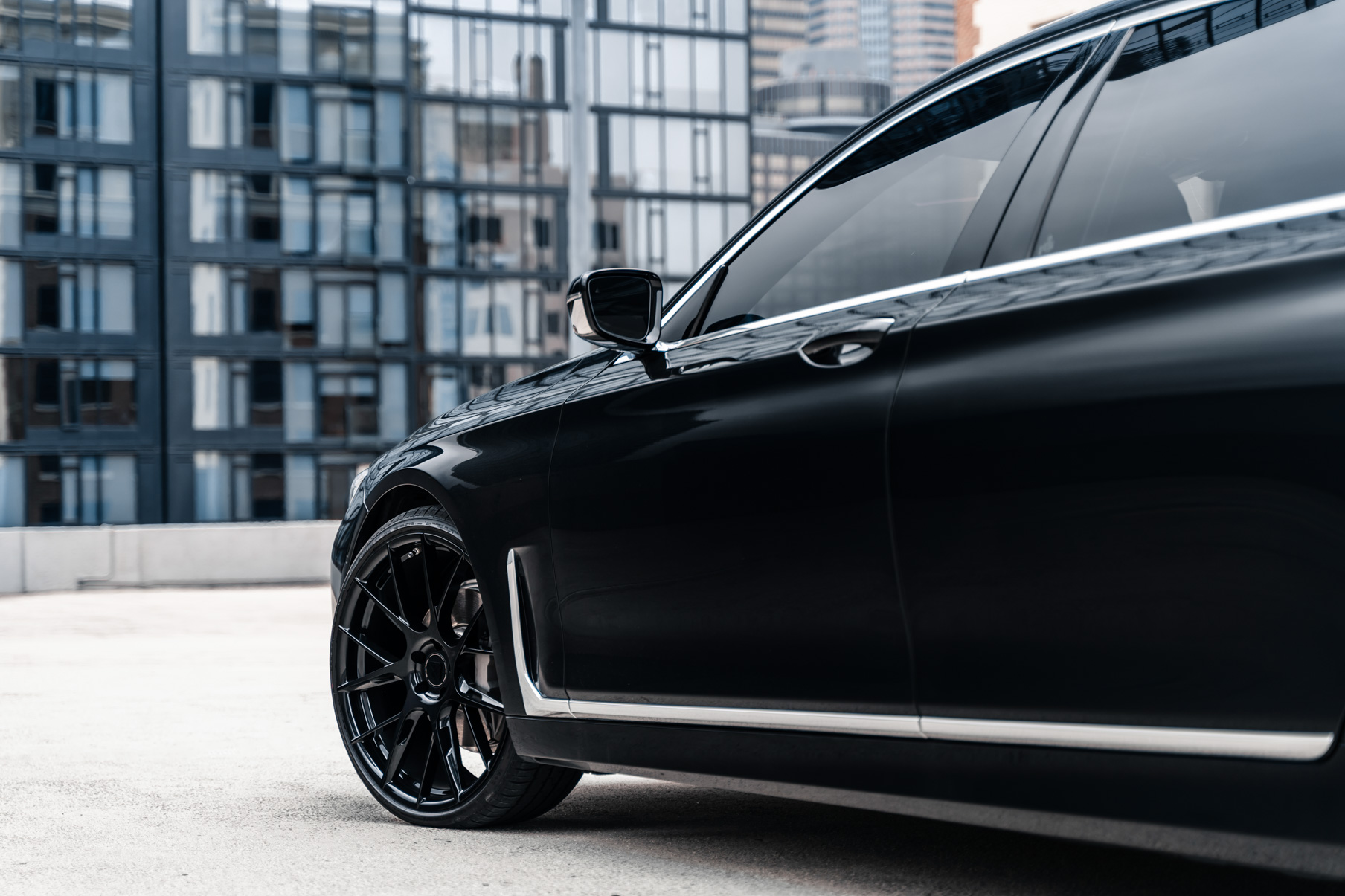 A 2020 BMW 740i on 20 Inch Blaque Diamond BD-F18 Gloss Black Wheels