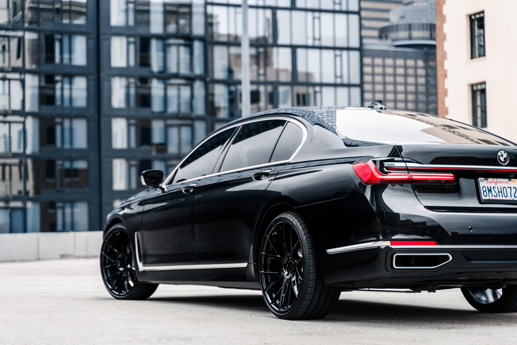 A 2020 BMW 740i on 20 Inch Blaque Diamond BD-F18 Gloss Black Wheels