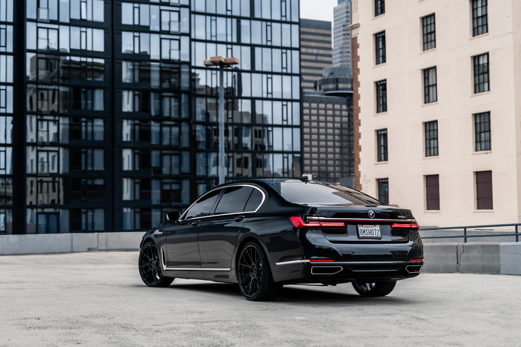 A 2020 BMW 740i on 20 Inch Blaque Diamond BD-F18 Gloss Black Wheels