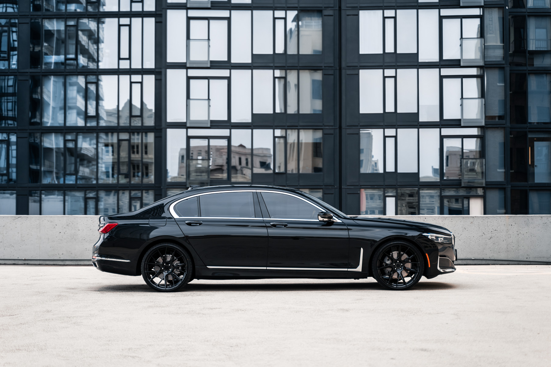 A 2020 BMW 740i on 20 Inch Blaque Diamond BD-F18 Gloss Black Wheels