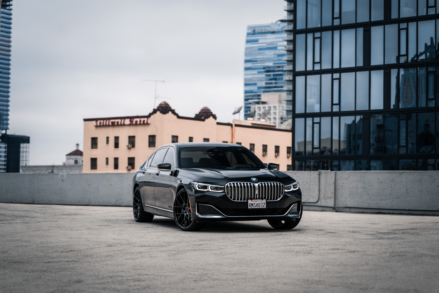 A 2020 BMW 740i on 20 Inch Blaque Diamond BD-F18 Gloss Black Wheels