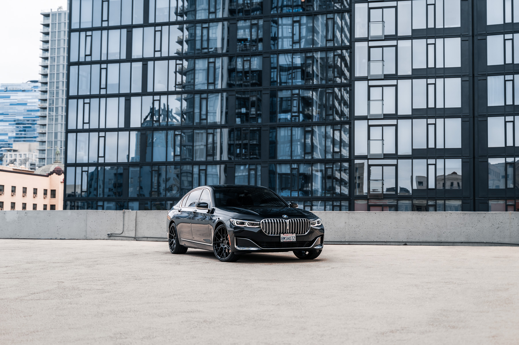 A 2020 BMW 740i on 20 Inch Blaque Diamond BD-F18 Gloss Black Wheels