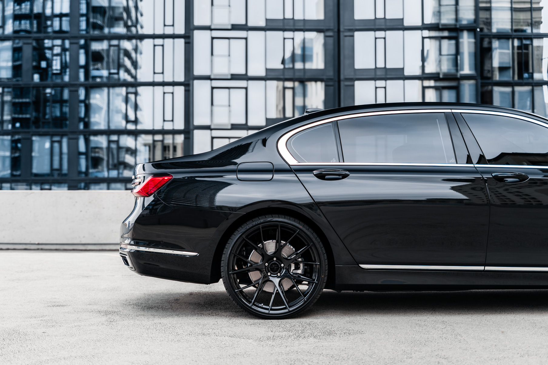 A 2020 BMW 740i on 20 Inch Blaque Diamond BD-F18 Gloss Black Wheels