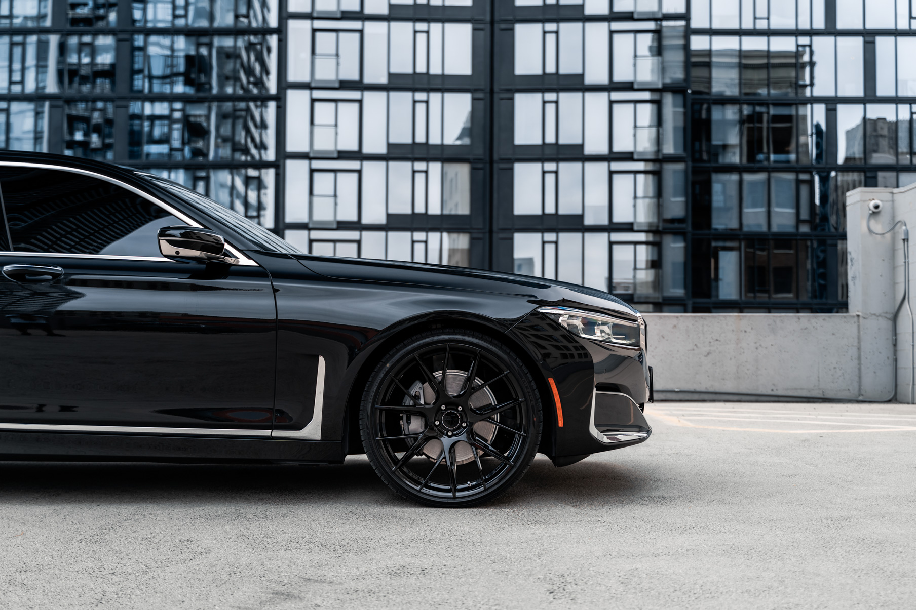 A 2020 BMW 740i on 20 Inch Blaque Diamond BD-F18 Gloss Black Wheels