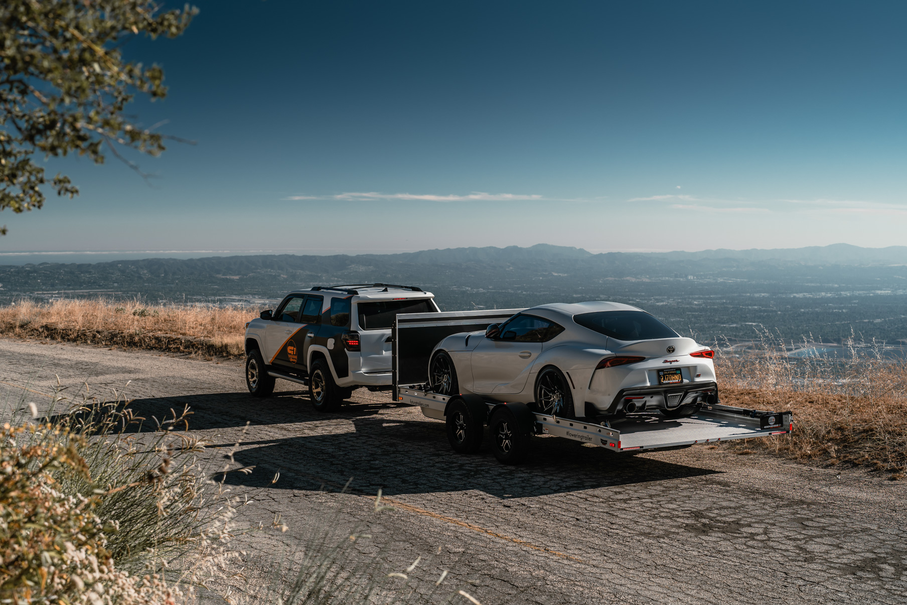 A 2020 Toyota 4Runner on 20 Inch Blaque Diamond BD-O728 Matte Bronze Wheels Towing Toyota Supra on Blaque Diamond BD-F20