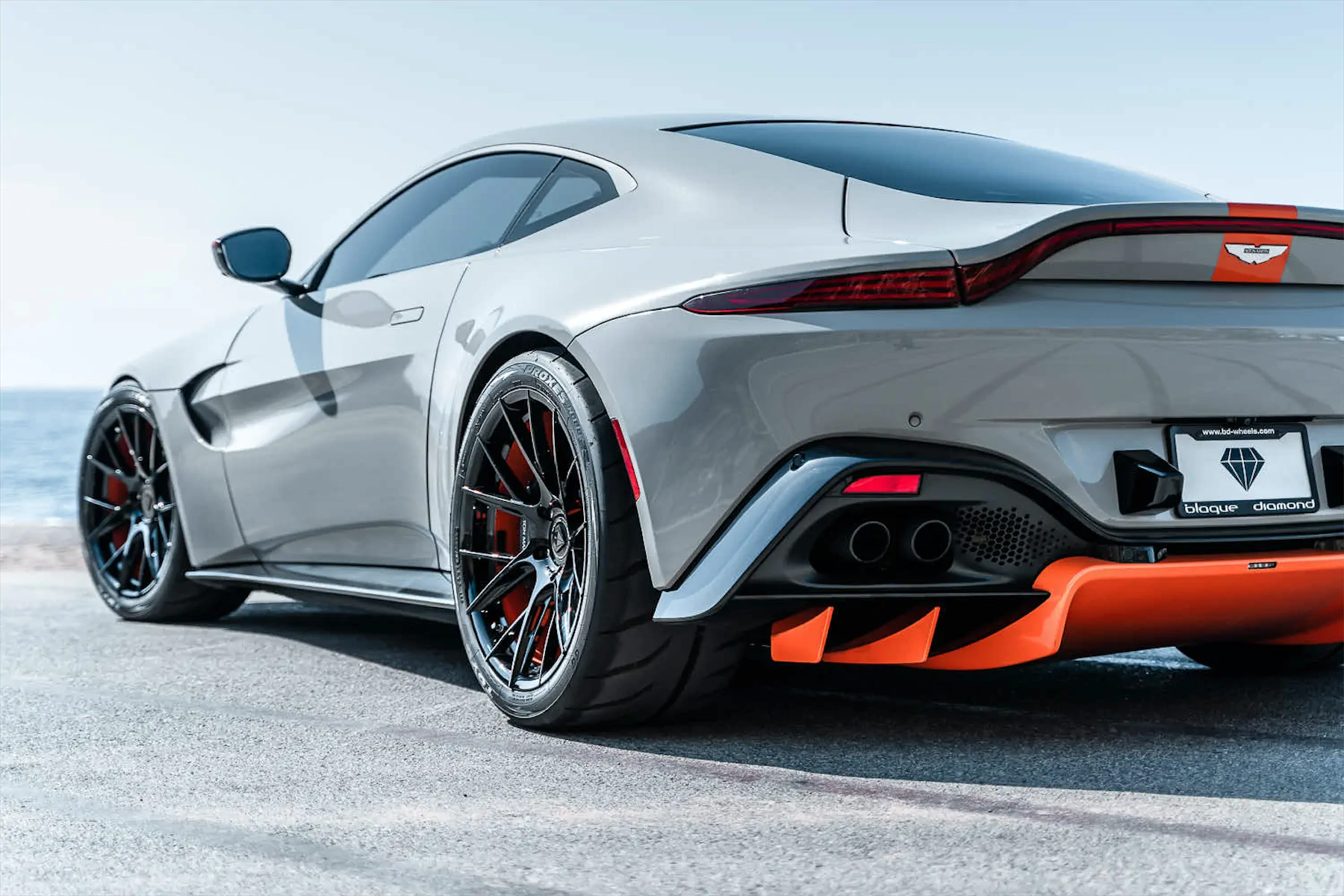 A 2020 Aston Martin Vantage on Blaque Diamond BD-F18 Gloss Black with Orange Barrel Wheels