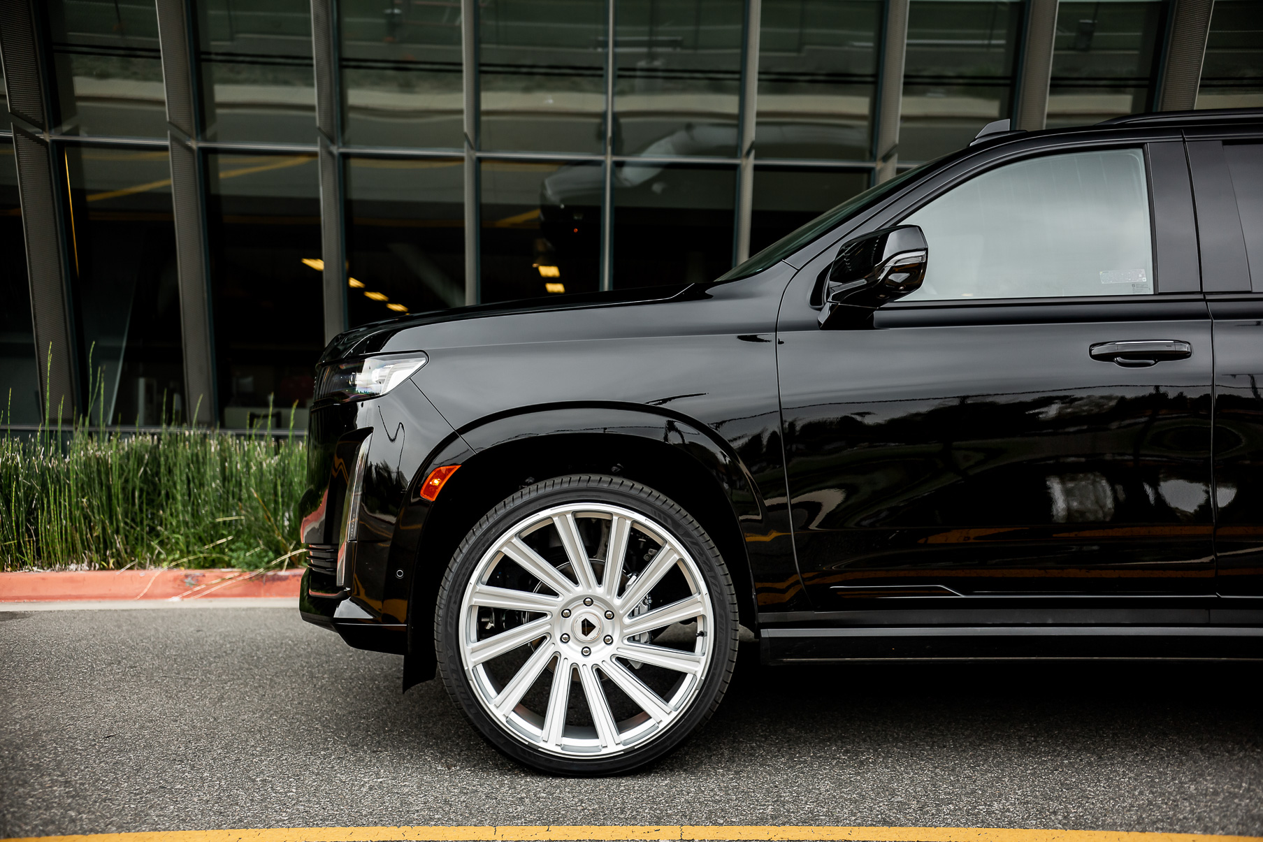 A 2022 Cadillac Escalade on Blaque Diamond BD-40 Brushed Silver Wheel with Floating Cap