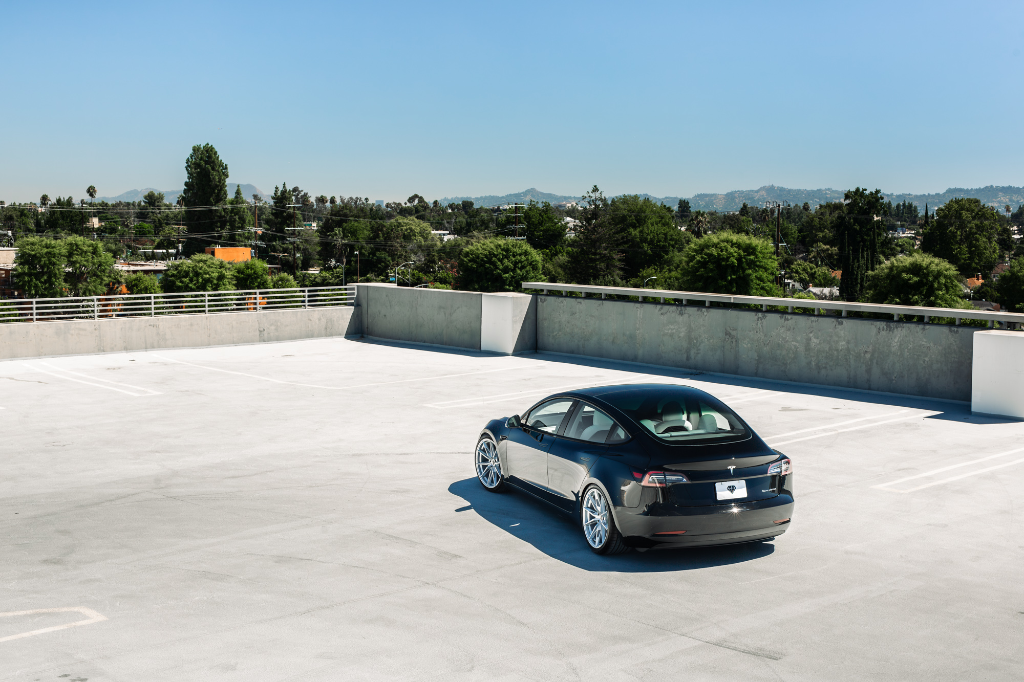 A 2022 Tesla Model 3 with Blaque Diamond BD-F29 Brushed Silver Wheels
