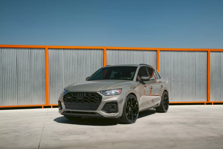 Audi SQ5 2022 equipped with BD-F25 Gloss Black Flow Forged Wheels parked against a modern orange-and-metal backdrop.